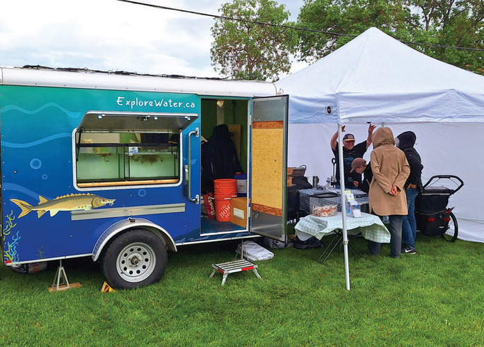 Kids look at The Minnow trailer that has displays present