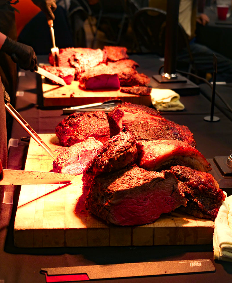 Meat getting sliced at a dinner