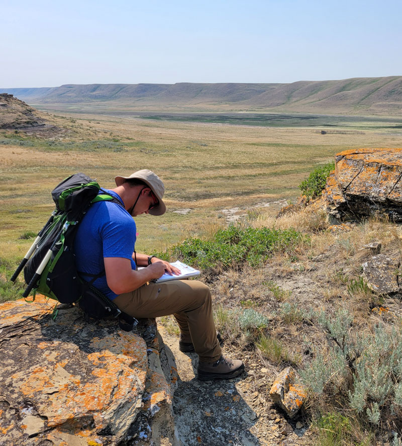 Biologist writing in a notepad