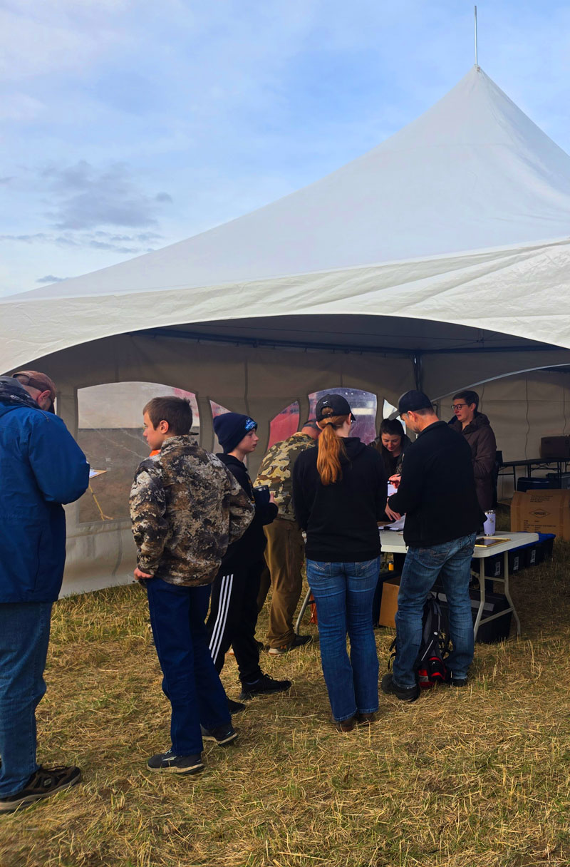 People lined up to go under Cooper equipment tent