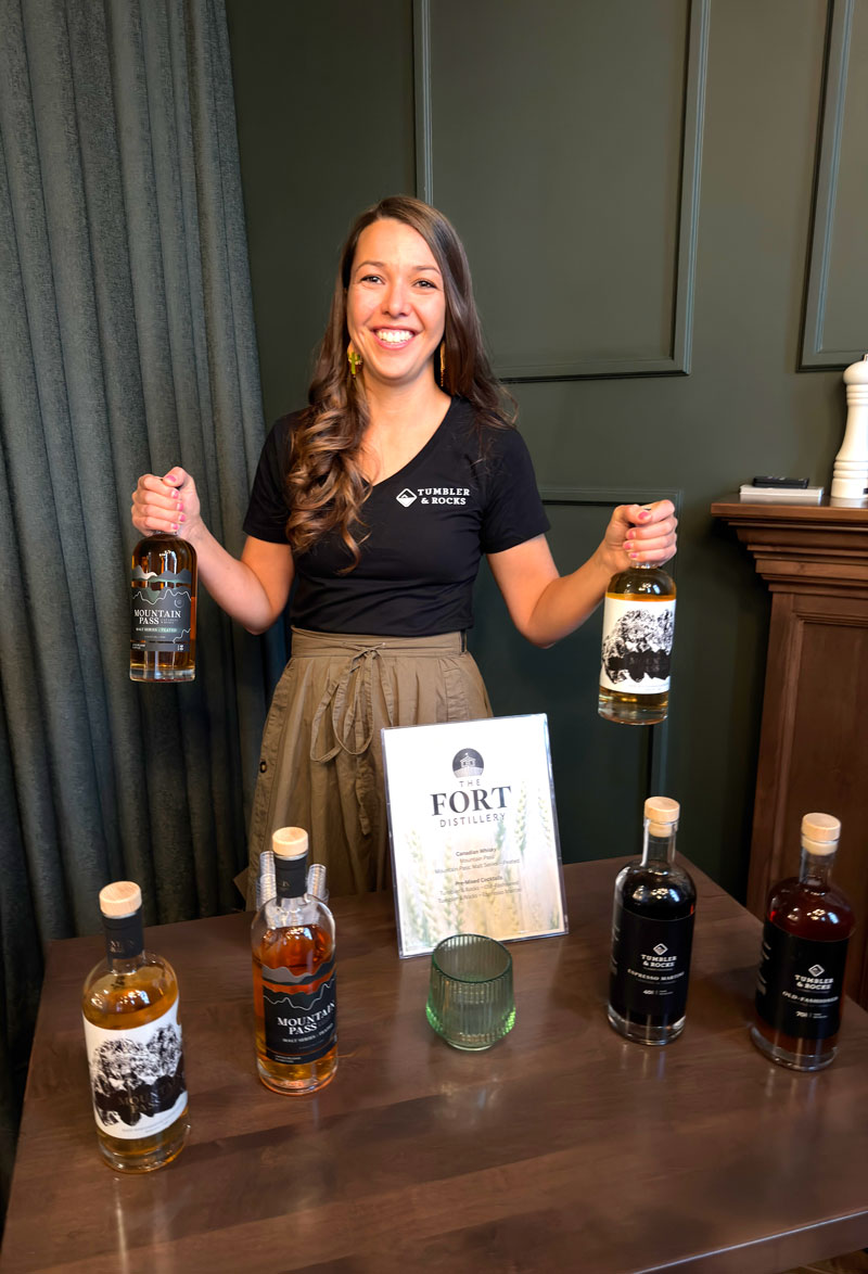 Girl holds whiskey bottles at an event